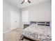 Bedroom features a ceiling fan, neutral walls, closet, and a window at 5620 Night Owl Ter, Palmetto, FL 34221