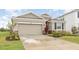 Charming single-story home with a two-car garage, stone accents, and well-maintained landscaping at 5620 Night Owl Ter, Palmetto, FL 34221