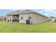 Well-maintained backyard featuring a covered patio and manicured lawn at 5620 Night Owl Ter, Palmetto, FL 34221