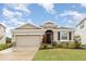 Charming single-story home with a two-car garage, stone accents, and well-maintained landscaping at 5620 Night Owl Ter, Palmetto, FL 34221