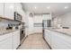 Modern kitchen with granite countertops, stainless steel appliances, and an island with seating at 5620 Night Owl Ter, Palmetto, FL 34221