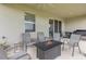 Inviting covered lanai features a fire pit table and comfortable seating, ideal for outdoor living at 5620 Night Owl Ter, Palmetto, FL 34221