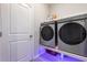 Modern laundry room with front-load washer and dryer, complemented by stylish under-shelf lighting at 5620 Night Owl Ter, Palmetto, FL 34221