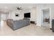 Spacious open-concept living room with tile flooring and a large ceiling fan at 5620 Night Owl Ter, Palmetto, FL 34221