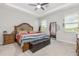 Main bedroom features a tray ceiling, ceiling fan, two windows, and furniture at 5620 Night Owl Ter, Palmetto, FL 34221