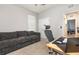 Functional home office featuring an ergonomic chair, modern desk setup, and comfortable couch at 5620 Night Owl Ter, Palmetto, FL 34221