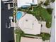 Aerial view of property showing the custom roof, lush landscaping, pool, and dock at 5782 Westshore Dr, New Port Richey, FL 34652