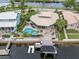 Aerial view of waterfront home with pool, dock and boat lift on canal at 5782 Westshore Dr, New Port Richey, FL 34652