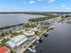 Community aerial showcasing waterfront home's backyard, pool, boat dock, and waterfront access at 5782 Westshore Dr, New Port Richey, FL 34652
