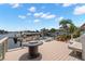 Waterfront deck featuring a fire pit, lounge seating, and scenic views of the canal at 5782 Westshore Dr, New Port Richey, FL 34652