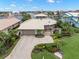 Exterior facade of home featuring lush landscaping, circular driveway, and waterfront views at 5782 Westshore Dr, New Port Richey, FL 34652