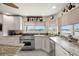 Bright kitchen featuring a Wolf range, granite countertops, and a view of the water at 5782 Westshore Dr, New Port Richey, FL 34652