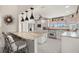 Beautiful kitchen with white cabinets, granite countertops, stainless appliances, and an eat-in island at 5782 Westshore Dr, New Port Richey, FL 34652
