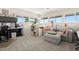 Cozy living room with plush gray sectional, bright windows, and adjacent office space at 5782 Westshore Dr, New Port Richey, FL 34652
