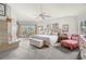 Bright main bedroom with a sitting area, fireplace, and a view of the water at 5782 Westshore Dr, New Port Richey, FL 34652