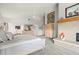 Spacious main bedroom with a fireplace, large windows, and neutral decor at 5782 Westshore Dr, New Port Richey, FL 34652