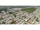 Aerial view of a neighborhood featuring houses, streets, and proximity to commercial areas and green spaces at 5840 Liddell Dr, New Port Richey, FL 34652
