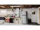 Utility basement area with workbench, stainless refrigerator, and storage at 5840 Liddell Dr, New Port Richey, FL 34652