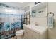 Cozy bathroom with charming floral shower curtain and a modern vanity, offering a clean, inviting space at 5840 Liddell Dr, New Port Richey, FL 34652