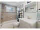 Updated bathroom with tiled walls, modern vanity, and shower-tub combination, providing a functional design at 5840 Liddell Dr, New Port Richey, FL 34652