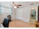 Home office/bedroom featuring laminate wood floors, a ceiling fan and closet at 5840 Liddell Dr, New Port Richey, FL 34652