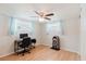 Home office/bedroom featuring laminate wood floors, a ceiling fan and a writing desk at 5840 Liddell Dr, New Port Richey, FL 34652