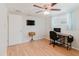 Home office/bedroom featuring laminate wood floors, a ceiling fan and a writing desk at 5840 Liddell Dr, New Port Richey, FL 34652