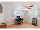 Home office/bedroom featuring laminate wood floors, a ceiling fan, a TV, and a writing desk at 5840 Liddell Dr, New Port Richey, FL 34652