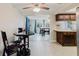 A cozy dining area with table and chairs leads into the living area and kitchen at 5840 Liddell Dr, New Port Richey, FL 34652