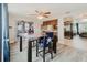 Bright dining area featuring wood-look floors, table with chairs, and kitchen bar access at 5840 Liddell Dr, New Port Richey, FL 34652