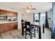 Bright dining area featuring wood-look floors, table with chairs, and kitchen bar access at 5840 Liddell Dr, New Port Richey, FL 34652