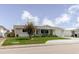 Welcoming single-story home with a covered front porch, a tidy lawn, and an attached garage at 5840 Liddell Dr, New Port Richey, FL 34652