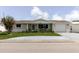 Charming single-story home featuring a cozy front porch, landscaped yard, and attached garage at 5840 Liddell Dr, New Port Richey, FL 34652