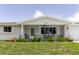 Inviting home exterior with a covered porch, a ceiling fan, and well-maintained landscaping at 5840 Liddell Dr, New Port Richey, FL 34652