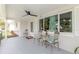 Cozy front porch features comfortable seating, a ceiling fan, and a welcoming atmosphere at 5840 Liddell Dr, New Port Richey, FL 34652