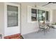 Inviting front porch with seating area, ceiling fan, and view of the neighborhood at 5840 Liddell Dr, New Port Richey, FL 34652