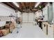 Cluttered garage with storage, work bench and garage door at 5840 Liddell Dr, New Port Richey, FL 34652