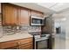 The well-appointed kitchen features stainless steel appliances and tiled backsplash at 5840 Liddell Dr, New Port Richey, FL 34652