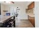 Kitchen has an island with an undermount sink, tile backsplash, and breakfast area at 5840 Liddell Dr, New Port Richey, FL 34652