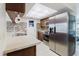 Modern kitchen featuring stainless steel appliances, updated cabinets, and stone countertops at 5840 Liddell Dr, New Port Richey, FL 34652