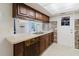 Charming kitchen with mosaic tile backsplash, modern countertops, and ample cabinet space at 5840 Liddell Dr, New Port Richey, FL 34652