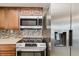 Updated kitchen featuring a stainless-steel refrigerator, oven, and microwave at 5840 Liddell Dr, New Port Richey, FL 34652