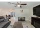 Cozy living room with wood-look tile flooring, ceiling fan, and modern decor in neutral tones at 5840 Liddell Dr, New Port Richey, FL 34652