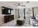 Living area features a large television, an electric fireplace, and wood-look flooring at 5840 Liddell Dr, New Port Richey, FL 34652