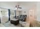 Cozy living room boasts wood-look flooring, neutral paint, and a large window with blue curtains at 5840 Liddell Dr, New Port Richey, FL 34652