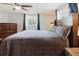 Comfortable bedroom with a large bed, ceiling fan, and natural light, creating a cozy retreat at 5840 Liddell Dr, New Port Richey, FL 34652