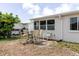 Backyard patio featuring outdoor dining set, seating, and attached home at 5840 Liddell Dr, New Port Richey, FL 34652