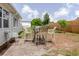 View of the backyard patio with dining set and fence at 5840 Liddell Dr, New Port Richey, FL 34652