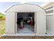 The open door of the shed reveals an interior filled with storage at 5840 Liddell Dr, New Port Richey, FL 34652