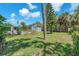 Well-maintained backyard with green grass, mature trees, and a view of the house at 5927 10Th N St, St Petersburg, FL 33703